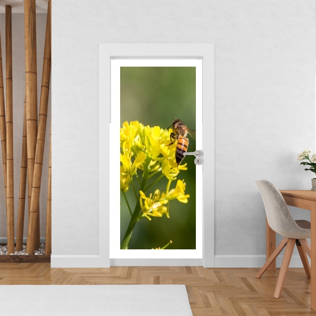 Poster de porte A bee in the yellow mustard flowers